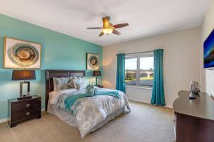 a bedroom with a bed and a ceiling fan at 535 -Villa Belvedere, A Stunning, Spacious 5 Bed Lake View Home with Pool and Spa in Davenport +37 photos