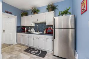 a kitchen with white cabinets and a stainless steel refrigerator at Stylish Private 2 Bed Apt in Harrisburg