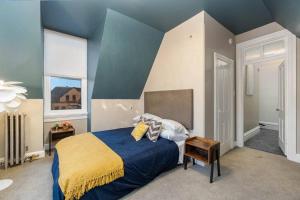 a bedroom with a large bed with a blue wall at Stylish Private 2 Bed Apt in Harrisburg