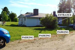 a house with signs that say entrance and parking at Warm ART room at home. in Ylitornio