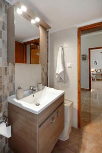 a bathroom with a sink and a mirror at Polixeni`s house in Ayios Nikolaos Sithonia