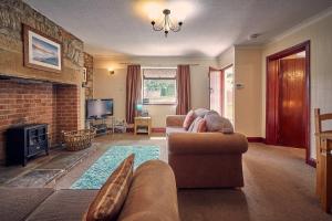 a living room with a couch and a fireplace at Host & Stay - Rose Cottage in Bamburgh