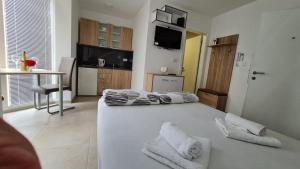a bedroom with a bed with towels on it at Studio Emilija A30 A42 in Veliko Gradište