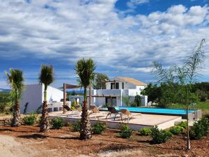 Villa con piscina y palmeras en Casa Padel El Perello, en Perelló