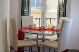 a table with chairs and a plate of food on it at Reservaloen Terrazas de la Catedral in Seville +89 photos