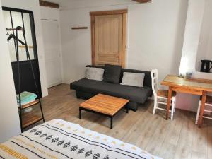 a living room with a couch and a table at La petite étoile d'hôtes en Mercantour in Saint-Dalmas-le-Selvage