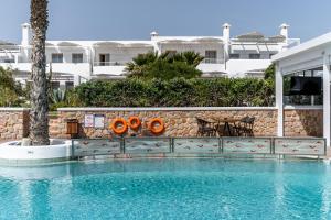 a swimming pool in front of a building at Marvarit Suites in Mesaria