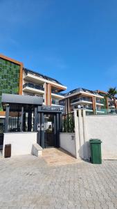 a building with a glass door in front of it at Family Apartment with pool Eden Valley in Alanya