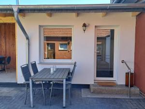 einen Tisch und Stühle vor einem Haus in der Unterkunft Ferienhaus Mandelbäumchen in Barth
