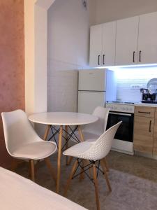 a kitchen with a table and chairs in a room at Apartman Cmiljanic in Igalo
