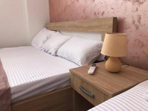 Postel nebo postele na pokoji v ubytování Apartman Cmiljanic