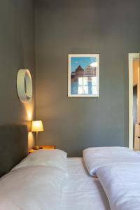 a bedroom with two beds and a picture on the wall at VIU Postcards from Gdansk in Gdańsk