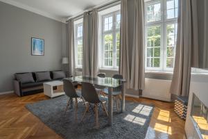 a living room with a glass table and chairs at VIU Postcards from Gdansk in Gdańsk