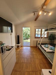 a room with two bunk beds and a kitchen at Stuga i Borgholms villa in Borgholm