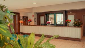 a hotel lobby with a reception desk with flowers at Cavan Crystal Hotel in Cavan +65 photos