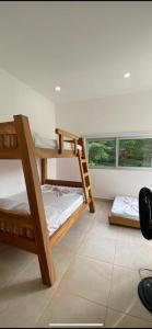 Ce dortoir comprend 2 lits superposés et une fenêtre. dans l'établissement Villa Guadalupe, à Puerto Triunfo
