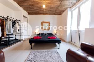 Sala de estar con cama y espejo en Surf Flat, en San Foca