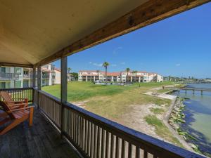 a balcony with a view of the water and houses at Bay Breeze Bungalow in Rockport