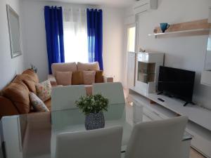 ein Wohnzimmer mit einem Tisch und einem Sofa in der Unterkunft Mediterráneo lux in Aguadulce