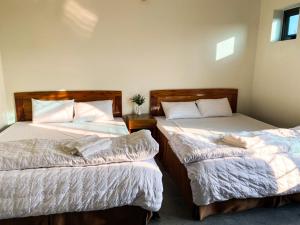 Giường trong phòng chung tại Hùng Yến Mộc Châu