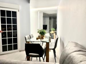 a living room with a table and chairs and a couch at Martina & Playa in Sanxenxo +9 photos