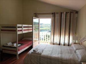 a bedroom with a bunk bed and a balcony at La Cariñosa in Naveces