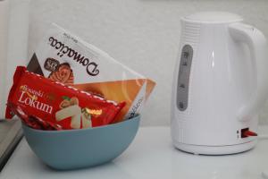 a bowl of food next to a scale and a mug at Apartment Kraljevac in Visoko +3 photos