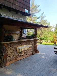 a building with a stone counter with a bench at Valvasorjev dom pod Stolom in Žirovnica