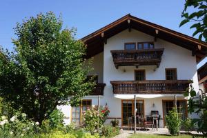 a house with a balcony on top of it at eleven Marquartstein in Marquartstein