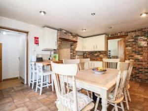 a kitchen and dining room with a table and chairs at 50 Harbour Road in Bognor Regis