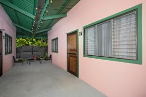 a room with a door and a table and a window at Manzanillo Caribbean Resort in Puerto Viejo