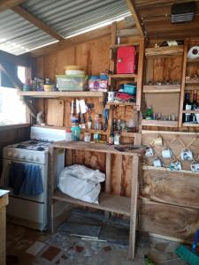 a kitchen with a stove and a table in it at Sustainable, Off-Grid and Organic Cabins on a Farm in a Secluded Cloud Forest, Ultra Low Carbon Footprint in Puntarenas