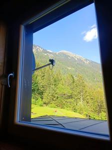 a window with a view of a mountain at Valvasorjev dom pod Stolom in Žirovnica