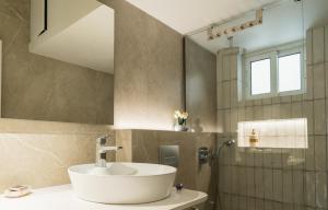 a bathroom with a sink and a shower at Noema Urban Living in Heraklio