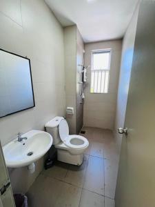 a bathroom with a toilet and a sink at Daddy Homes Golden Hills pasar malam cameron 3bedroom in Brinchang