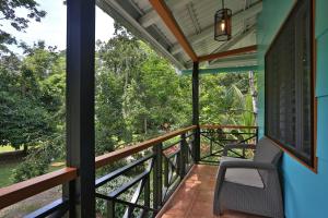 a balcony with a view of the forest at Manzanillo Caribbean Resort in Puerto Viejo