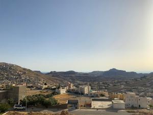 a view of a city with mountains in the background at Petra Sola Home in Wadi Musa