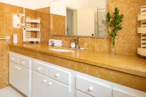 a bathroom with a sink and a mirror at Cascais Garden Villa in Cascais