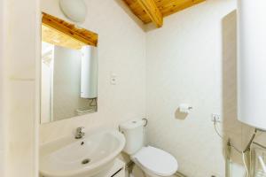 a white bathroom with a toilet and a sink at Terimex in Pogorzelica