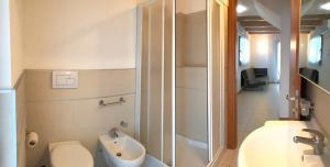 a bathroom with a toilet and a sink and a shower at Bibione MasterVillage Family in Bibione +60 photos