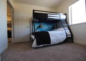 a bedroom with a bunk bed in a room at Moab Oasis in Moab