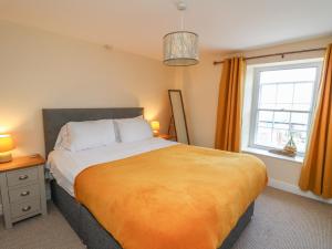 a bedroom with a large bed and a window at Bari in Aberaeron