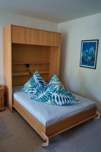 1 cama con cabecero de madera y 2 almohadas en Im Beilsteiner Mühlental, en Beilstein