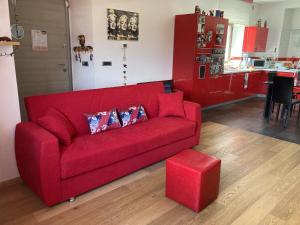 a red couch with two pillows in a living room at Stephanie's Home in Pettorano sul Gizio