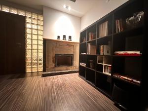 a living room with a fireplace and book shelves at A Luxury Apt 170 m2 3 Bedroom 2 Bathroom at Bestekar Avenue at the heart of Ankara in Ankara