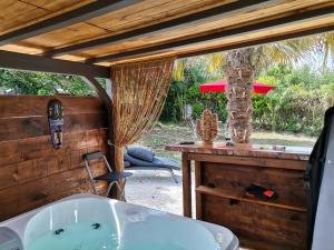 a bathroom with a tub and a table with a chair at maison avec jaccuzi privatif in Nérac