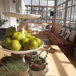 eine Schale mit grünem Obst auf einem Tisch im Wohnzimmer in der Unterkunft Durr 32 in Dilidschan