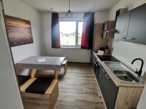 a small kitchen with a table and a sink at Ferienwohnung Florine 