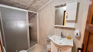 a bathroom with a shower and a sink at Bahar Villa Pansiyon in Uzungöl +34 photos