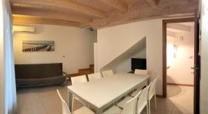 a dining room with a white table and chairs at Bibione MasterVillage Family in Bibione